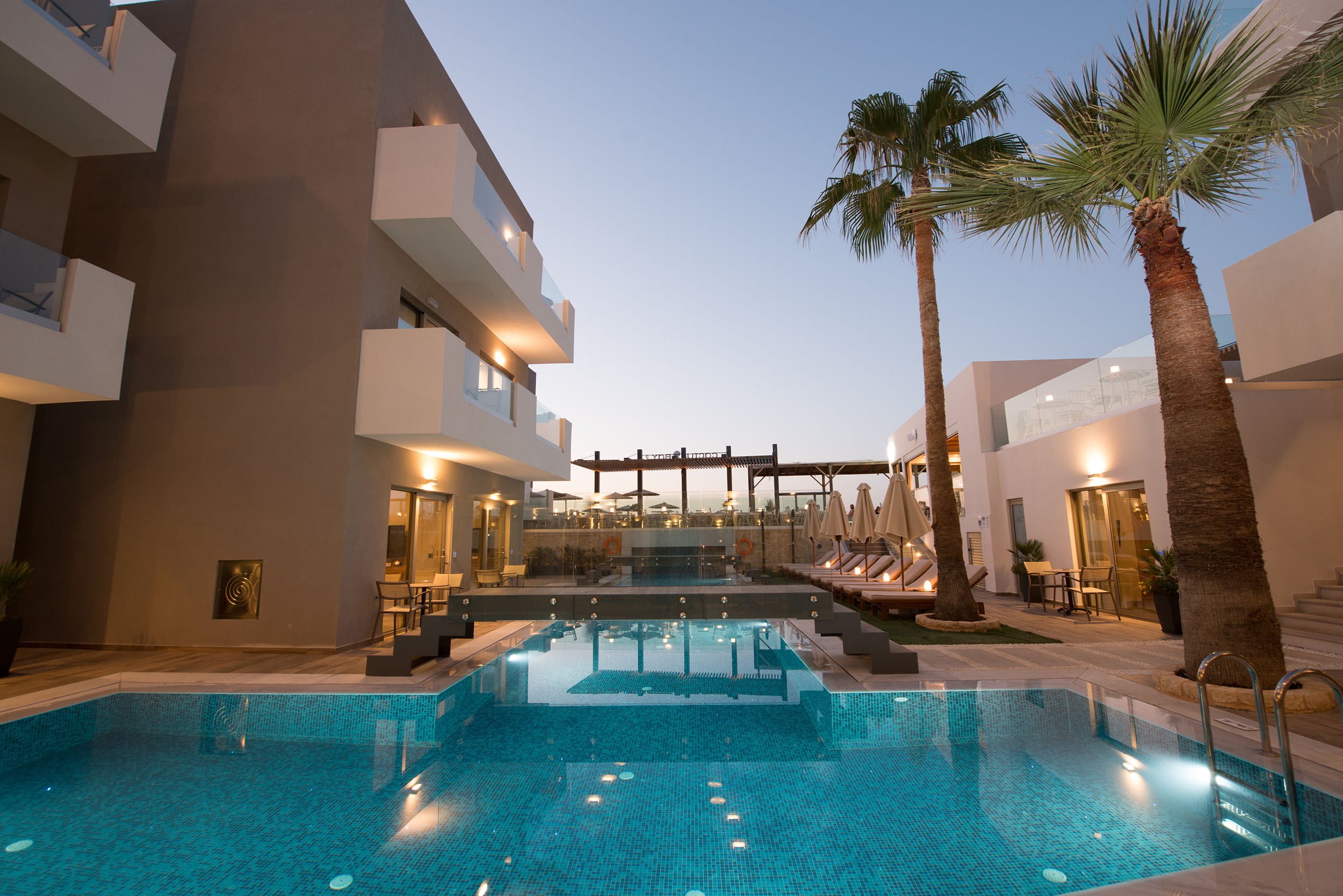 Exterior evening view of Cactus Bay Hotel rooms, pool bar and rooms