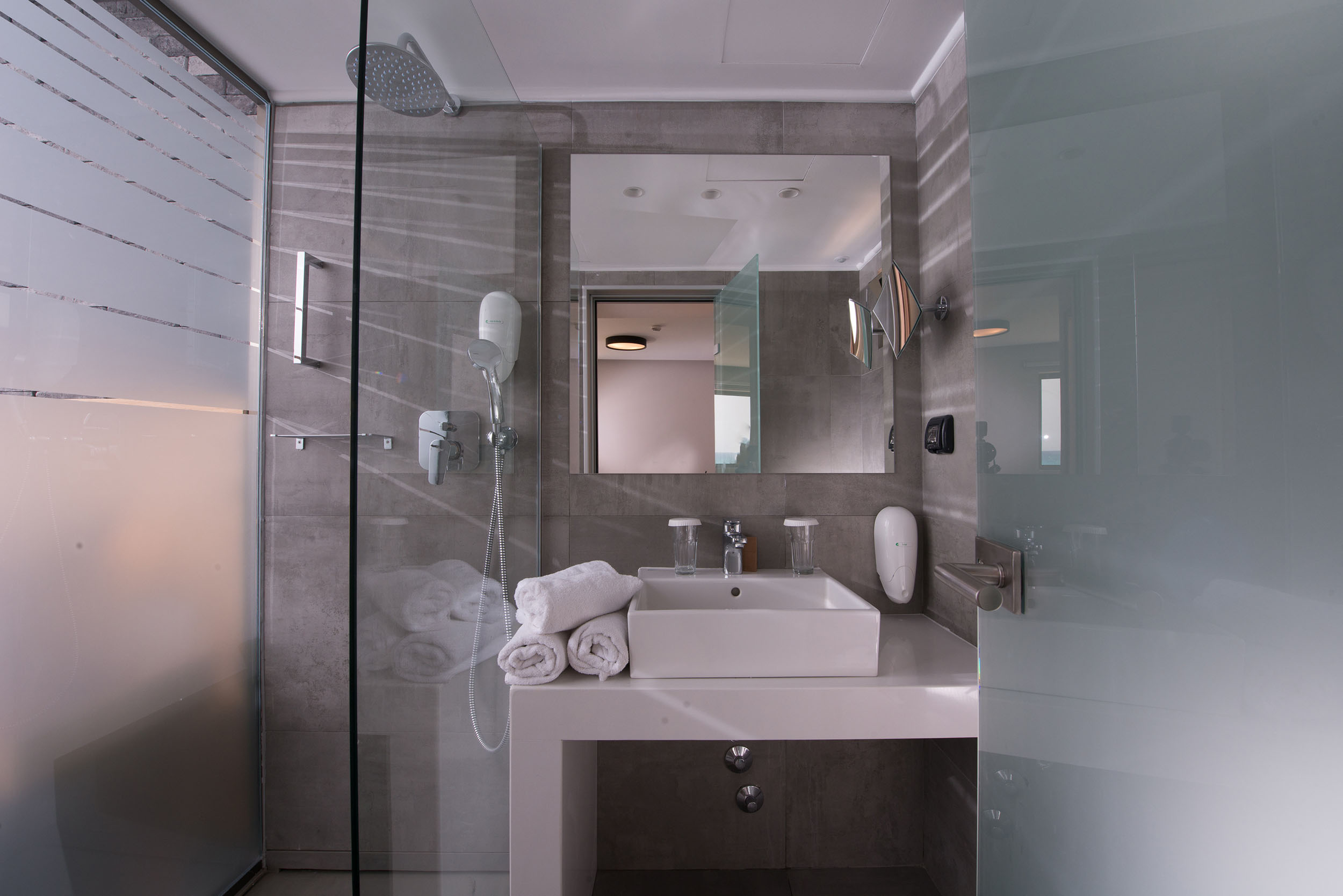Hotel bathroom with shower and glass door