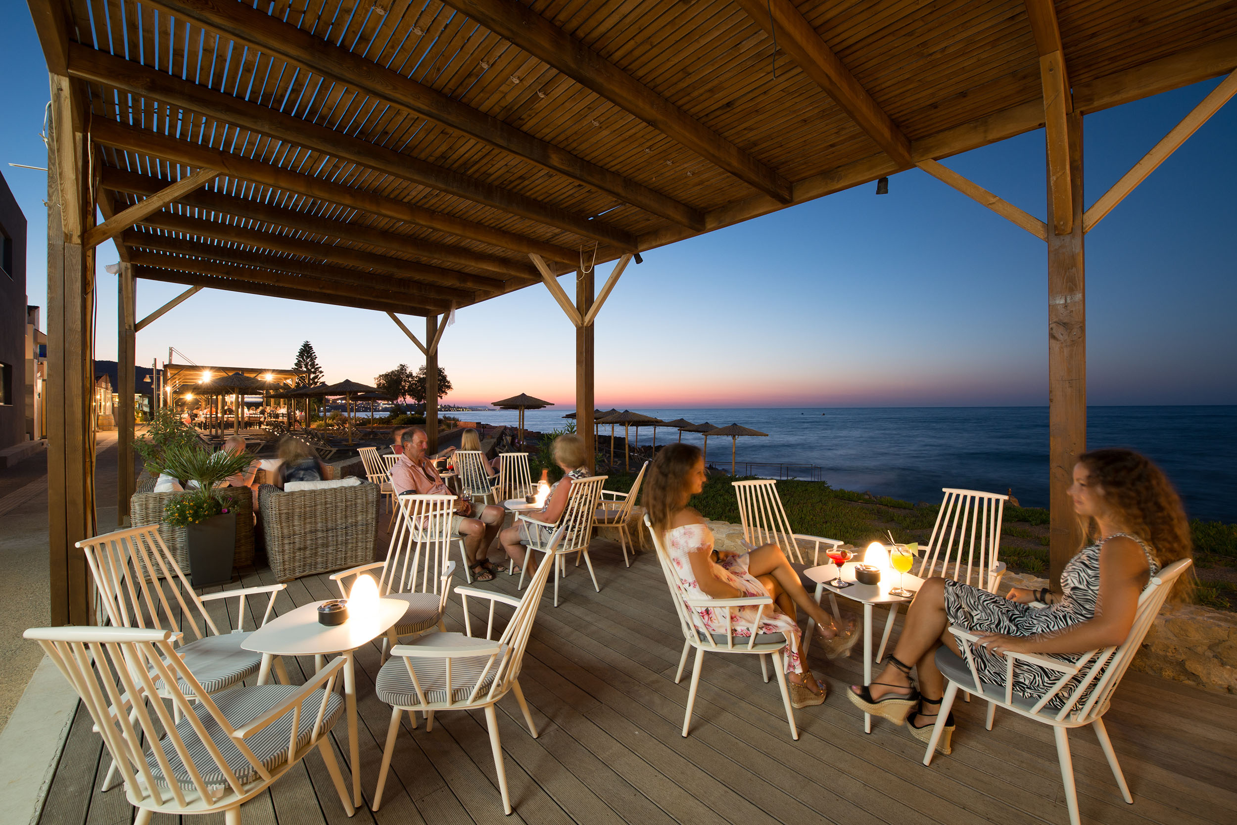 Evening view of exterior bar of Cactus Bay Hotel