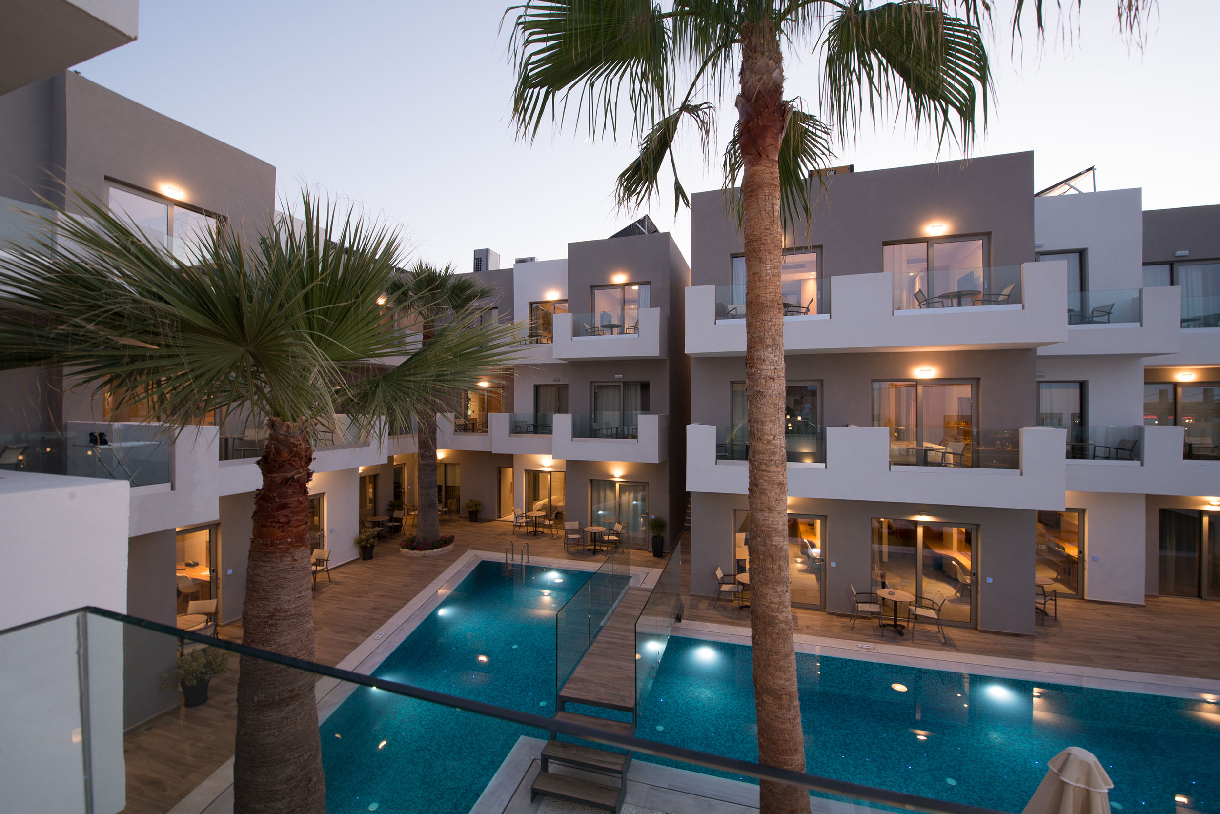 Exterior evening view of Cactus Bay Hotel rooms, pool bar and rooms