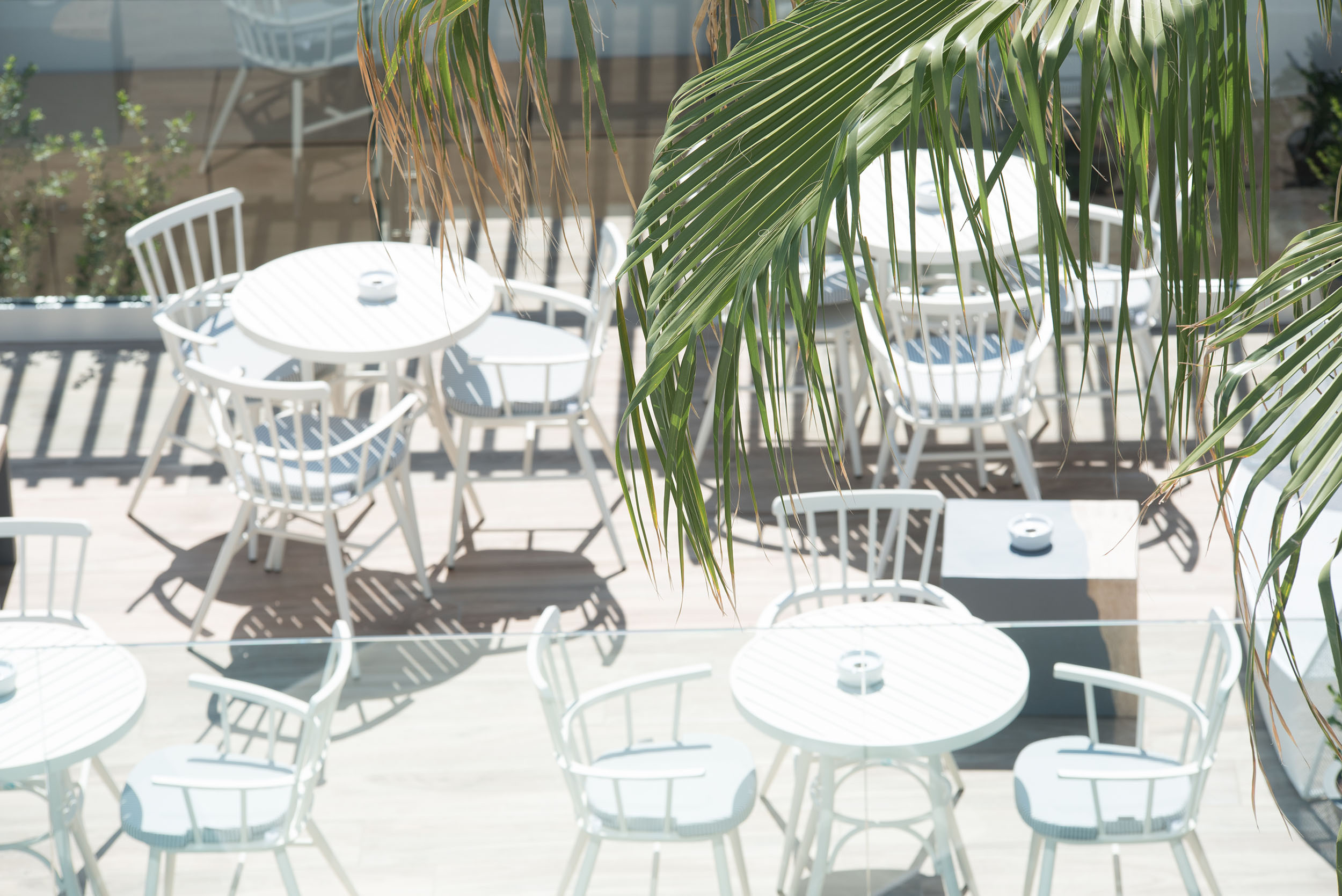Exterior view of white tables at Cactus Bay Hotel