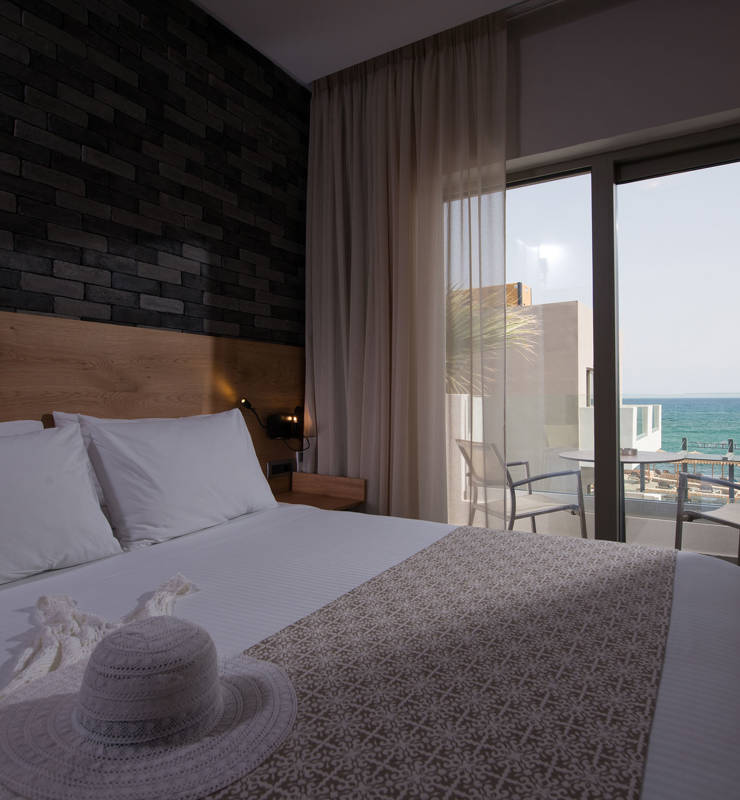 Cactus bay hotel room with a double bed and a balcony overlooking the sea
